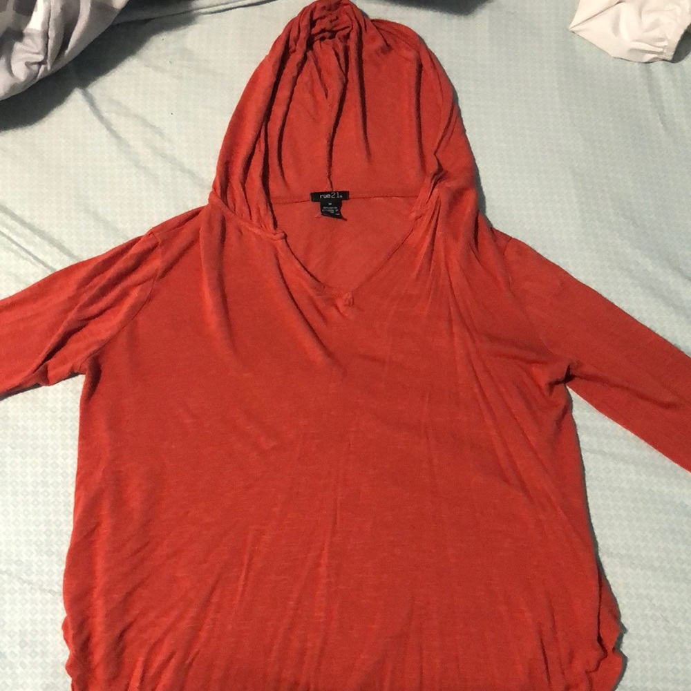 A burnt orange long sleeve with hood